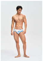 UPRO men's Frangipani Swim Brief – Blue Yellow Floral – studio model view, photo 1 of 3
