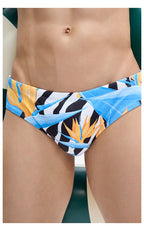 UPRO men's Bird of Paradise Print Swim Brief – Blue Orange Botanical – front close-up of the blue and orange botanical print and waistband