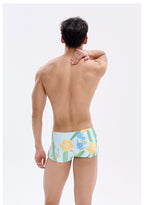 UPRO men's Narcissus Print Swim Trunks – Green Floral – studio model view, photo 3 of 3