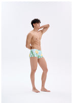 UPRO men's Narcissus Print Swim Trunks – Green Floral – studio model view, photo 1 of 3